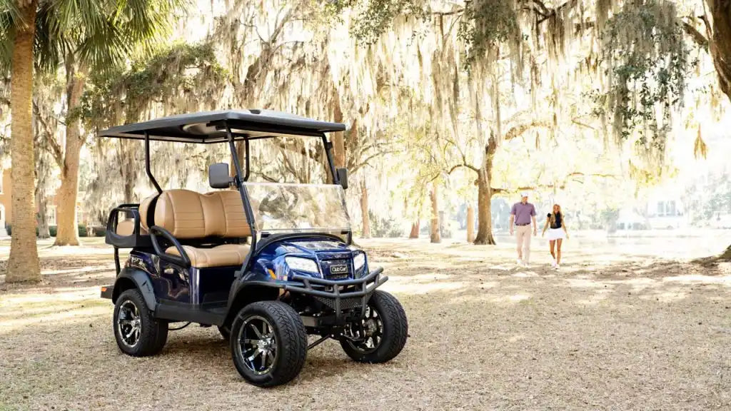 A dark blue four-seater golf cart with tan seats and black wheels.